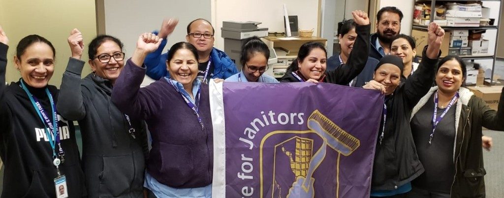 Janitors from the BC Hydro site in Surrey gathered around an SEIU flag